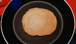 an oat crepe in the pan